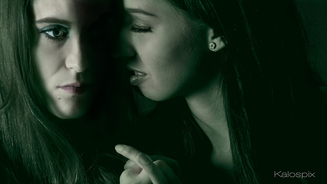 Moody green-toned double portrait, two faces close together